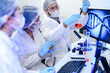 © ultramansk - Biochemists analyzing chemical compound reactions while monitoring molecular DNA structures on screens. Diverse research team collaborating in advanced biotechnology lab setting.