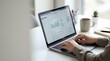 © Yuliia - Business professional analyzing financial data and charts on laptop computer in modern office workspace for corporate reporting and analytics.