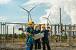 © ultramansk - Wind energy engineering team inspecting high-voltage substation infrastructure at renewable power plant. Specialists coordinating grid expansion strategy.