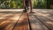 © LimeSky - The deck is being polished and colored. The timber is brown with a natural texture, reflecting effort and commitment to a lovely outdoor area
