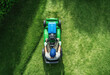 © Wendy - Lawn Care Professional Mowing Grass in a Well-Maintained Garden
