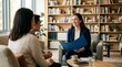 © ZenVision - Friendly female professional consultant smiling and discussing documents with a couple in a modern office with bookshelves