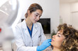 © Graphicroyalty - Professional dermatologist examining young woman's face in aesthetic clinic. Female doctor in white coat consulting patient before beauty treatment. Healthcare and skin care medical concept image.