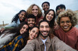 © Xavier Lorenzo - Big group portrait of diverse young people together outdoors. Multiracial happy millennial male and female friends having fun together. Unity and friendship concept. Focus on man in the center