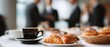 © Olga Ко - Business coffee break with fresh croissants and coffee cup on table. Blurred group of businessmen in suits networking and talking in the background during a corporate conference. Panoramic banner.
