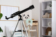 © Pixel-Shot - Modern telescope in stylish children's room, closeup