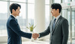 © Solim - Business Handshake Agreement in Modern Office