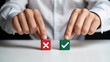 © shakilhossain - Close-up of person's hands touching red 'X' and green tick mark blocks