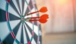© skakter24 - Darts hitting bullseye on dartboard with three orange arrows clustered in the center, target success and accuracy concept featuring dart, aim, precision with focus and achievement elements for goal,