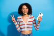 © deagreez - Young chic multiethnic woman smiling holding smartphone and posing for lifestyle photo
