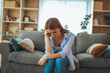 © Dragana Gordic - Sad Young Woman Sitting On Couch In Living Room Feeling Depressed And Stressed At Home