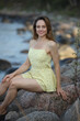 © zhagunov_a - Woman in yellow dress sitting on seaside rocks