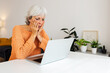 © Xavier Lorenzo - Worried mature professional businesswoman reading bad news on laptop screen