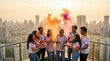 © Yash - Indian family celebrating Holi festival with colors on city rooftop
