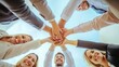 © Awais - Diverse business team stacking hands in unity and cooperation