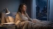 © Kang - Stressed mature woman sitting alone in bed at night suffering from insomnia.