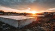 © riptii rittika - High quality image of concrete foundation slabs at construction site under a dramatic sunset sky, urban development concept.