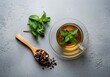 © Fajar - Cup of herbal tea with mint and spoon
