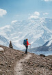 © Soloviova Liudmyla - Lonely Climber woman with backpack and trekking poles during Lenin peak ascent enjoying mountain peaks and glaciers. Extreme active people, high-altitude mountaineering concept shot