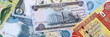 © Larysa - Iraqi dinar money bills pile on table. Iraq banknotes of IQD currency close up.