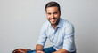 © Hamza - Confident young man smiling in casual business attire
