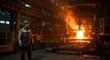 © sayekti - A worker in a protective suit standing near a large furnace emitting bright orange flames and smoke in an industrial setting