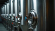 © Pete - Large stainless steel tanks line a modern winery cellar, used for white wine fermentation. Equipment features valves for process control and hygiene.