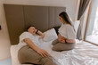 © Yauhen - A pregnant woman and her partner smiling at each other on a bed. The scene conveys love, expectation, and domestic happiness. Perfect for family planning and maternity health articles.