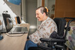 © PintoArt - Woman smiling using assistive technology laptop for online communication