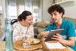 © PintoArt - Healthcare professional showing tablet to laughing woman