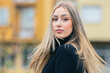 © carballo - portrait of a young woman with long blonde hair on the street