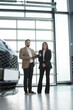 © Lana - People in a car salon. Man buying the car. Elegant women with handsome man
