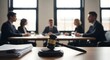 © Rezmin - Gavel on desk in courtroom. blurred lawyers or business people meeting in background. legal justice concept