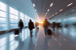 © tania_wild - Motion blur of people walking in a modern airport terminal with bright sunlight streaming in