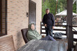 © lara-sh - Dialogue aged men in verbal dispute on home porch highlighting tension disagreement communication and relationship issues.