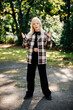 © Alena Vilgelm - Teenage girl posing in plaid jacket standing on sunny park path