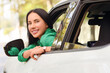 © Pixel-Shot - Beautiful young happy woman sitting in car