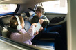 © AntonioDiaz - Sibling arguments and conflict during a family road trip, brother and sister fighting over a digital tablet in the car