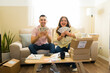 © AntonioDiaz - Excited couple showing earned cash from successful online side hustle, celebrating financial freedom and e-commerce business profit