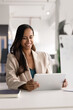 © fizkes - Attractive young businesswoman working on tablet at modern workplace, planning strategy, review report or preparing presentation for upcoming meeting. Digital communication, apps and modern tech usage