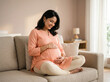 © Someone Cooked Here - indian pregnant woman in peach maternity kurti sitting cross legged indoors representing motherhood journey prenatal happiness and maternity wellness campaign concept
