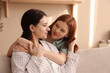 © New Africa - Mother and her teenage daughter in pajamas spending time together at home