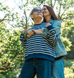 © olezzo - Tender hug between a happy senior mother and her adult daughter in a spring garden on Mother's Day.
