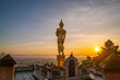 © Narong Niemhom - 1. A golden standing Buddha faces the rising sun at Wat Khao Noi, glowing gently as morning light spreads across the horizon above Nan city.