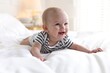 © New Africa - Cute little baby on bed at home