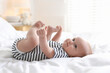 © New Africa - Cute little baby on bed at home