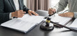 © Charlie's - Lawyer Legal counsel presents to the client a signed contract with gavel and legal law. justice and lawyer Business partnership meeting concept