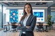 © HappiLens - Confident female technology executive standing in modern office environment with analytics screens in background. Concept of leadership, innovation and digital transformation.