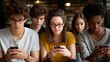 © forenna - Diverse group of teenagers sitting together but each looking at separate smartphone screens, perfect for digital isolation concept, social media addiction, modern youth behavior, technology