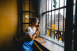 © Grow Photography - Coffee. Beautiful Girl Drinking Tea or Coffee in Cafe travel to Vietnam, Dark Warm Colors Toned